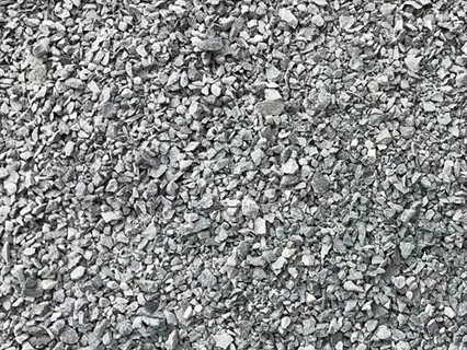 close-up texture of gray gravel stone mulch covering the ground