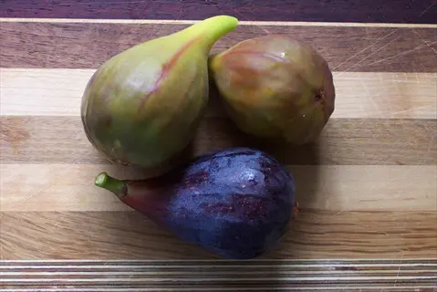 three osborne prolific figs on a wooden cutting board